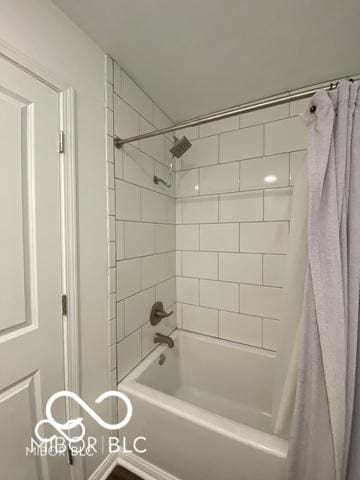 bathroom featuring shower / tub combo with curtain