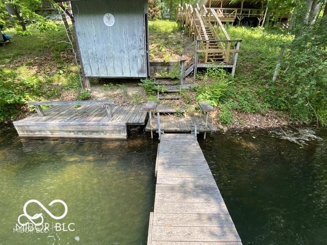 dock area featuring stairs and a water view