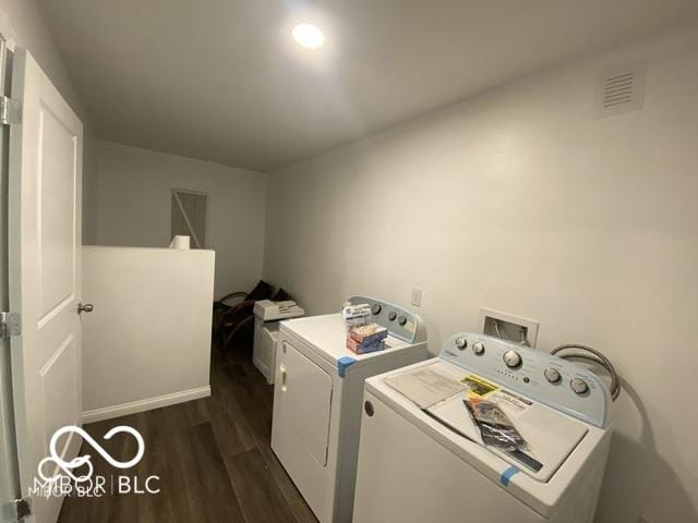 laundry room featuring dark wood-style floors, laundry area, visible vents, and separate washer and dryer