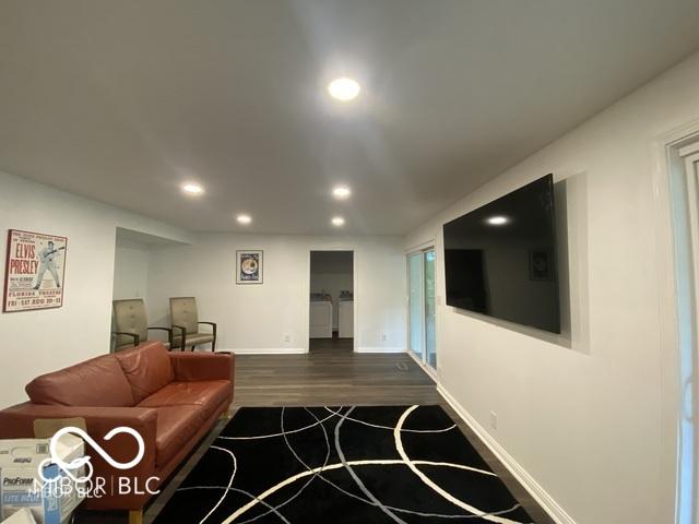 living room featuring baseboards, dark wood-type flooring, and recessed lighting