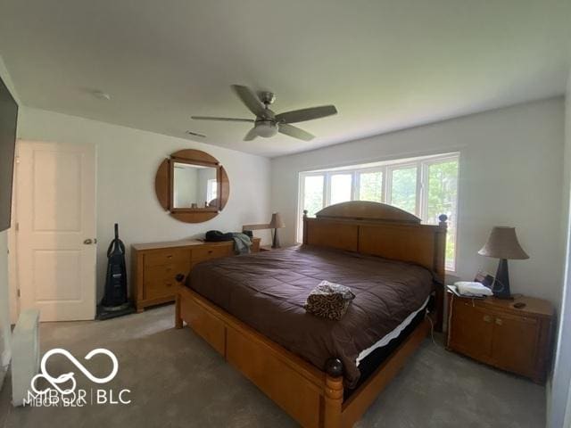 bedroom with a ceiling fan and light carpet