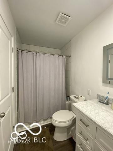 full bath with shower / tub combo, visible vents, toilet, wood finished floors, and vanity