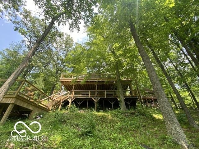 back of house featuring a deck and stairway