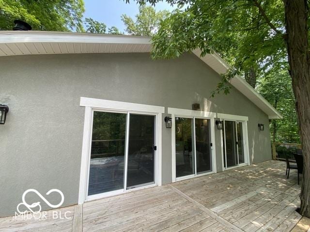 back of house with a deck and stucco siding