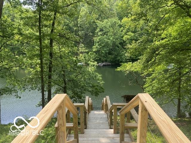 dock area with a forest view and a water view