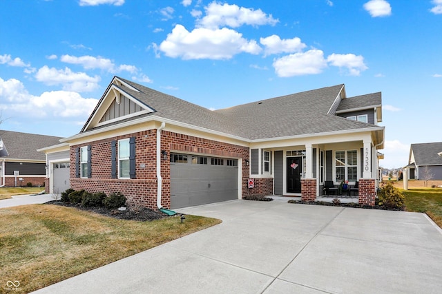 view of front facade with a garage, covered porch, and a front lawn