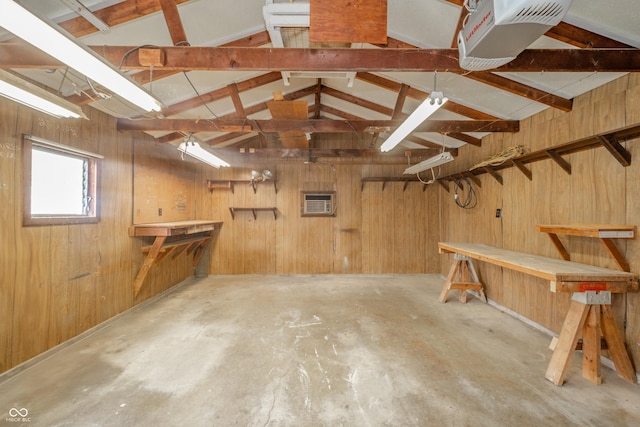 interior space featuring wood walls and a workshop area