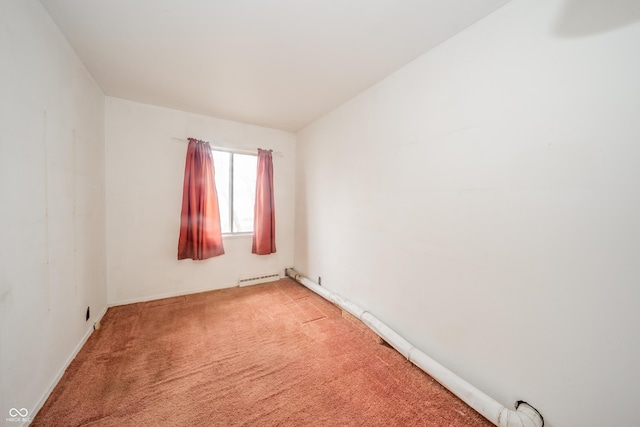 empty room featuring light colored carpet and a baseboard heating unit