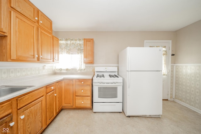 kitchen featuring sink and white appliances