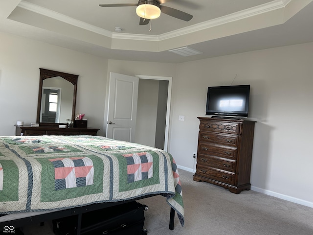 carpeted bedroom featuring ceiling fan, ornamental molding, and a raised ceiling