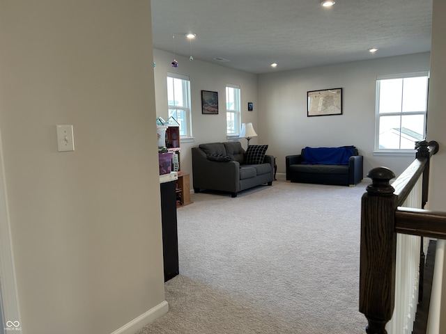 living room featuring light carpet and a textured ceiling