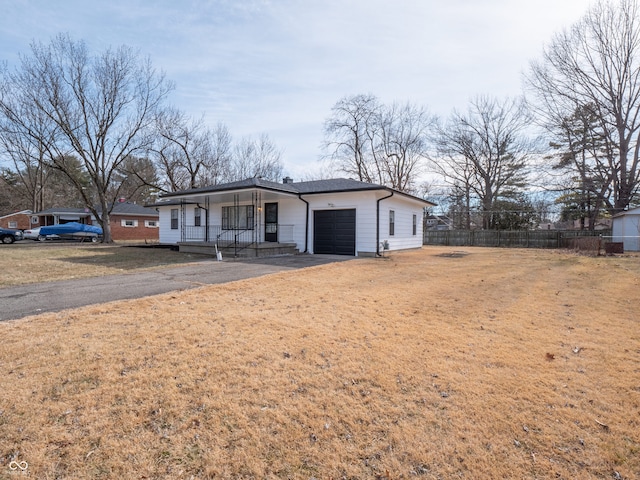 view of front of house with a garage, a front lawn, and a porch