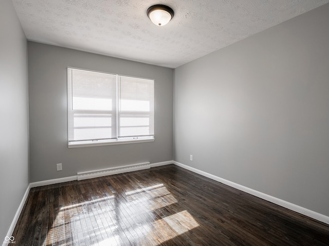 unfurnished room featuring a baseboard radiator, a textured ceiling, and dark hardwood / wood-style flooring