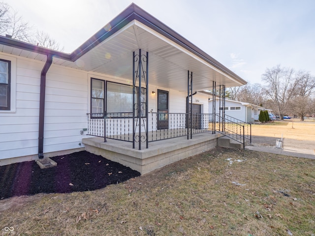 exterior space with covered porch and a front yard