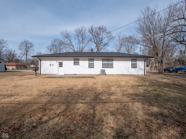 back of house with central AC and a lawn