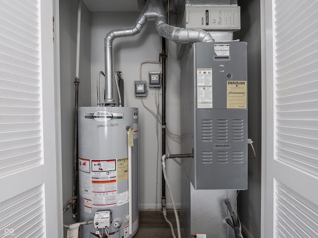 utility room with heating unit and gas water heater