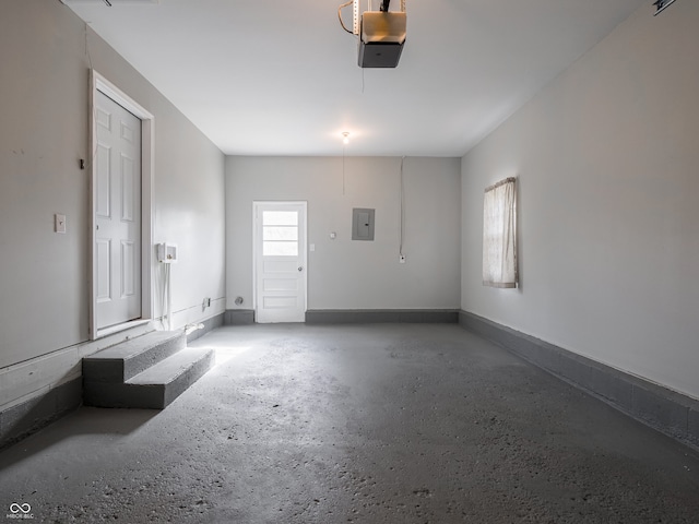 garage with a garage door opener and electric panel