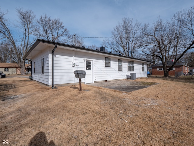 exterior space featuring a yard and central air condition unit