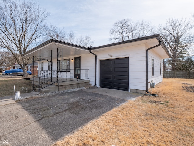 single story home featuring a garage and covered porch