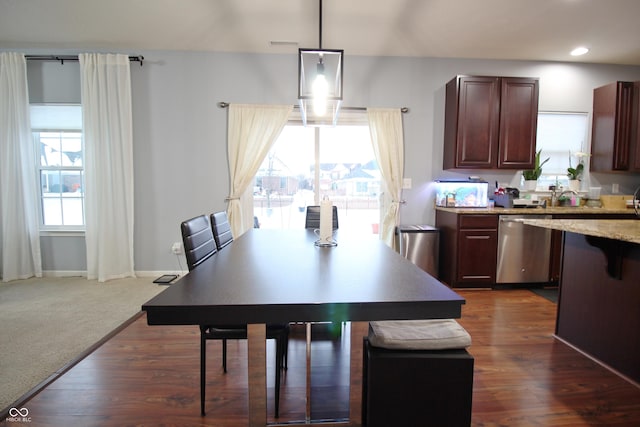 dining area with dark hardwood / wood-style floors