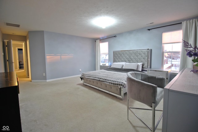 carpeted bedroom featuring a textured ceiling