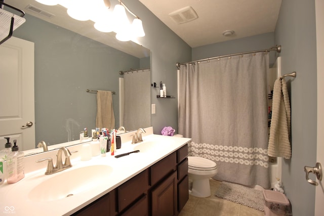 bathroom with tile patterned flooring, vanity, curtained shower, and toilet