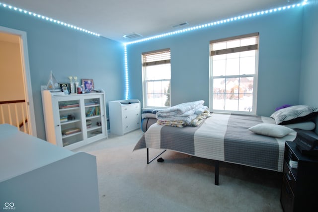 bedroom with light colored carpet