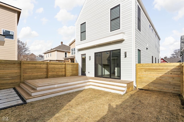 rear view of house featuring a deck