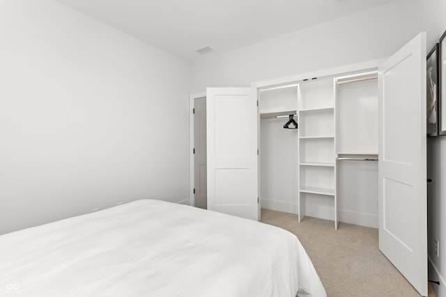 carpeted bedroom with a closet