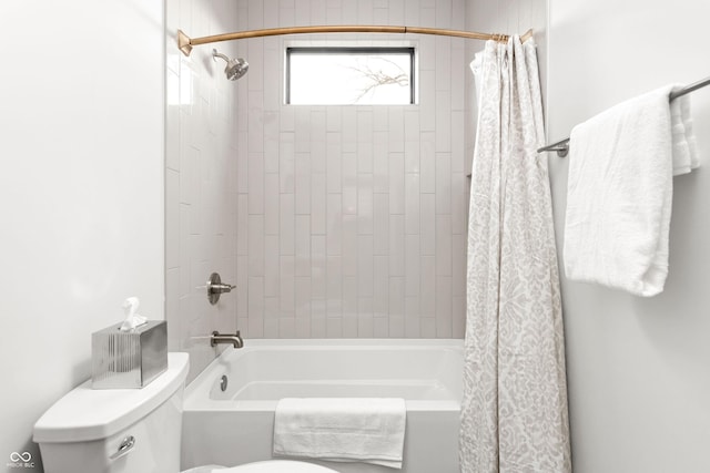 bathroom featuring shower / bath combo with shower curtain and toilet