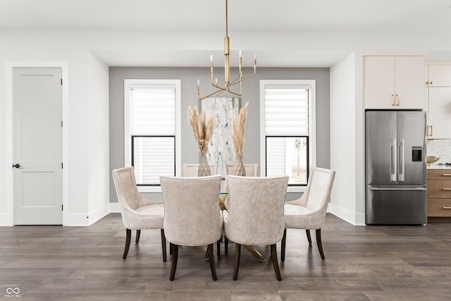 dining room featuring dark hardwood / wood-style flooring, plenty of natural light, and a chandelier