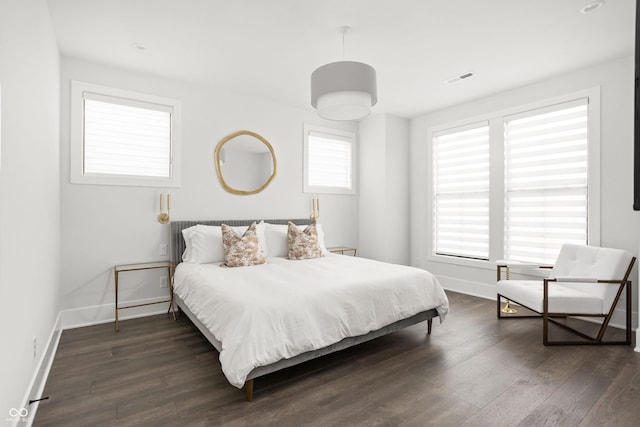 bedroom with dark hardwood / wood-style floors