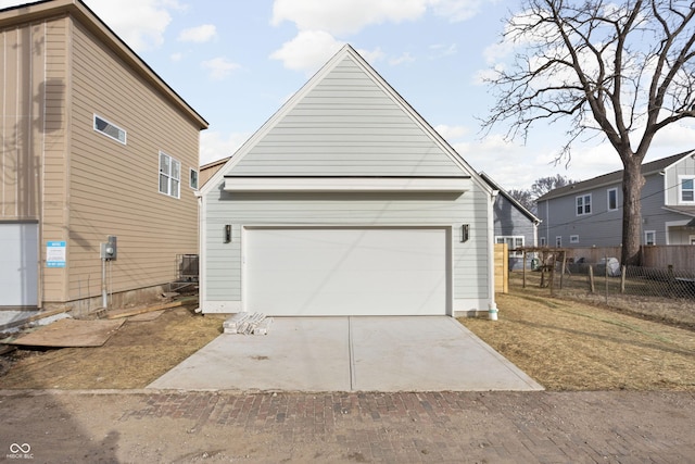 view of front facade featuring a garage and an outbuilding