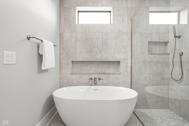 bathroom with separate shower and tub and a wealth of natural light