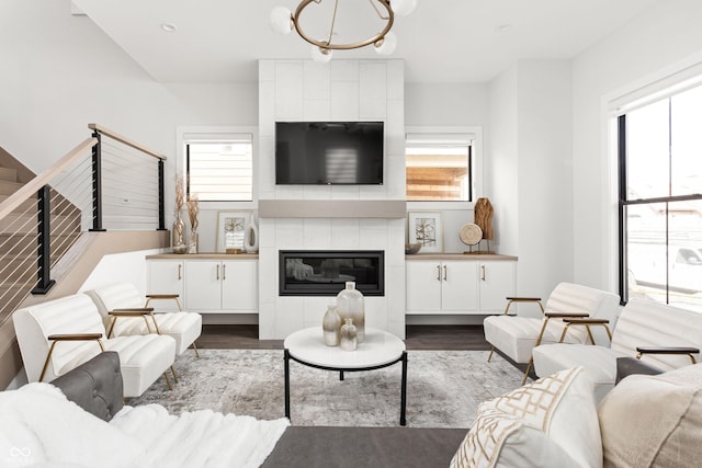 living room featuring a healthy amount of sunlight, a fireplace, and dark hardwood / wood-style flooring