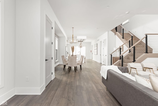 dining area featuring an AC wall unit, a chandelier, and dark hardwood / wood-style flooring