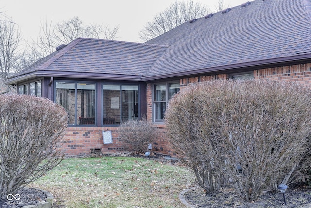 view of side of property with a lawn