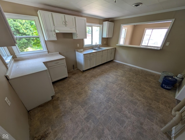 603 W 33rd St, Anderson, IN 46013 - kitchen featuring crown molding, white cabinets, and light countertops