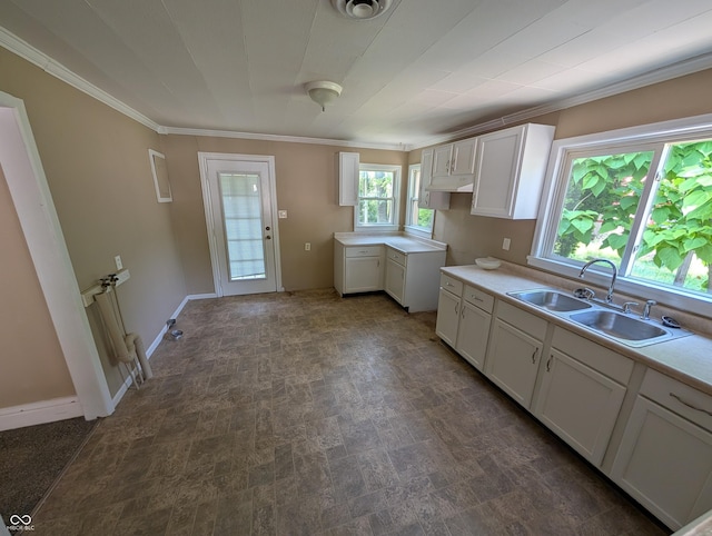 603 W 33rd St, Anderson, IN 46013 - kitchen featuring crown molding, white cabinetry, and light countertops