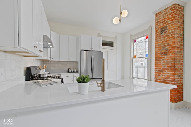 kitchen featuring stove, white cabinetry, stainless steel fridge, and kitchen peninsula