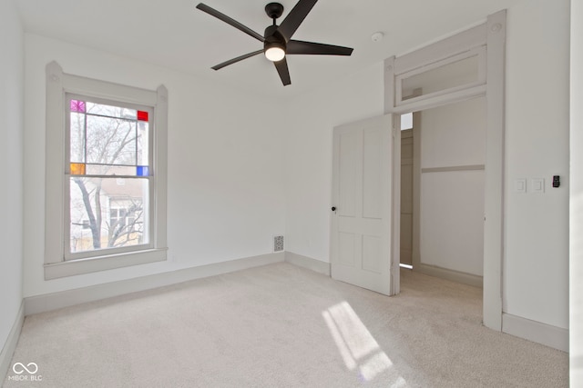 unfurnished bedroom featuring ceiling fan and light carpet