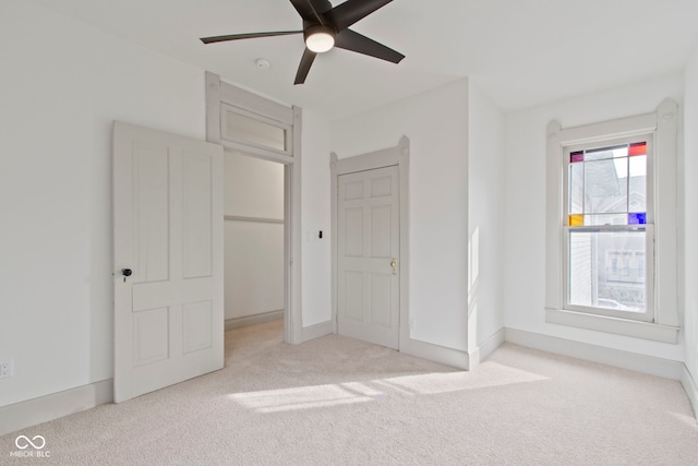 unfurnished bedroom featuring light colored carpet and ceiling fan