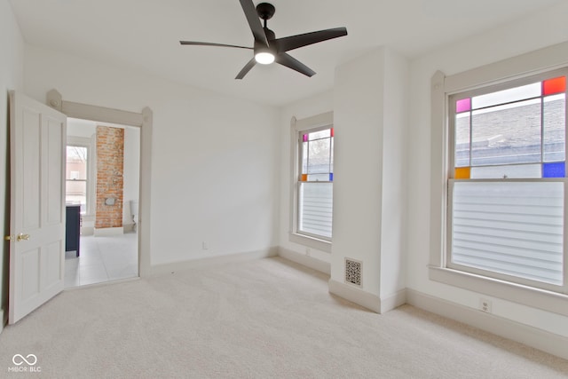 empty room with light carpet and ceiling fan