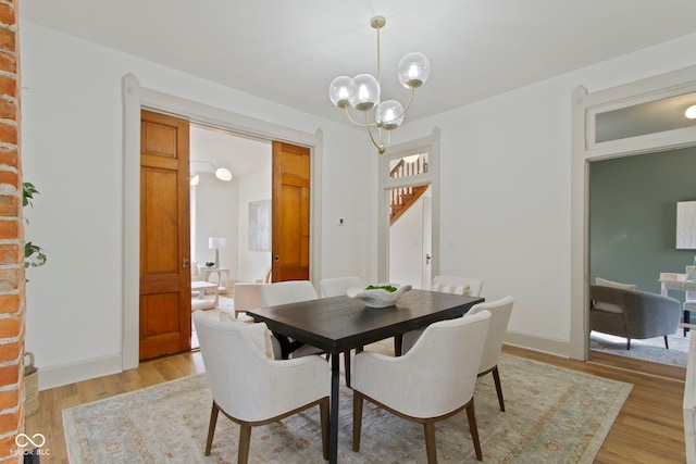 dining space with an inviting chandelier and light wood-type flooring