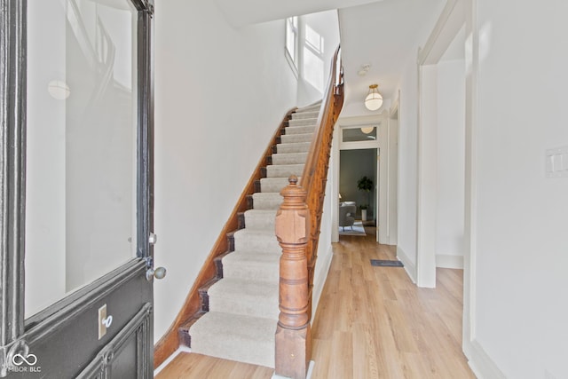 stairs featuring hardwood / wood-style flooring