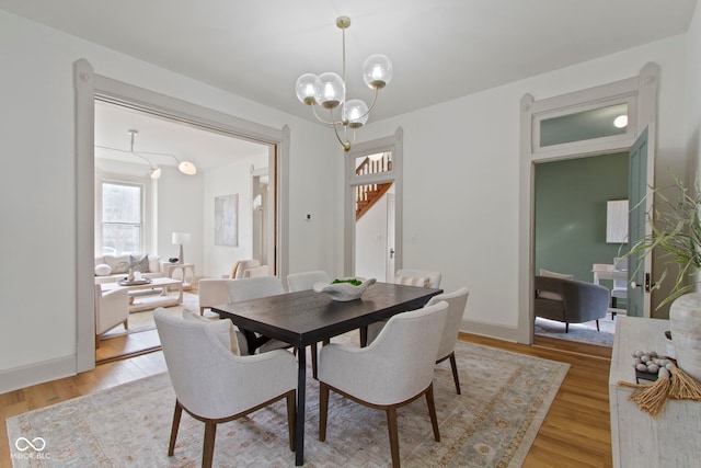 dining room with a chandelier and light wood-type flooring