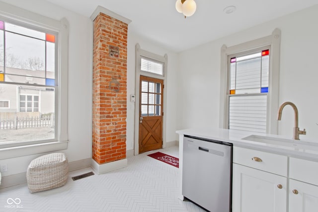 kitchen featuring white cabinetry, sink, and dishwasher