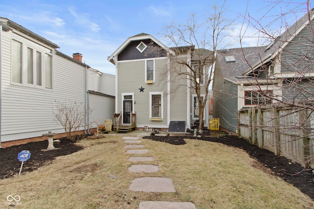 rear view of house featuring a lawn