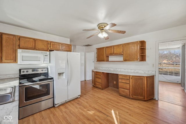 kitchen featuring sink, white appliances, light hardwood / wood-style flooring, ceiling fan, and built in desk