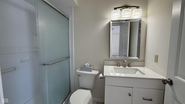 bathroom featuring vanity, walk in shower, and toilet